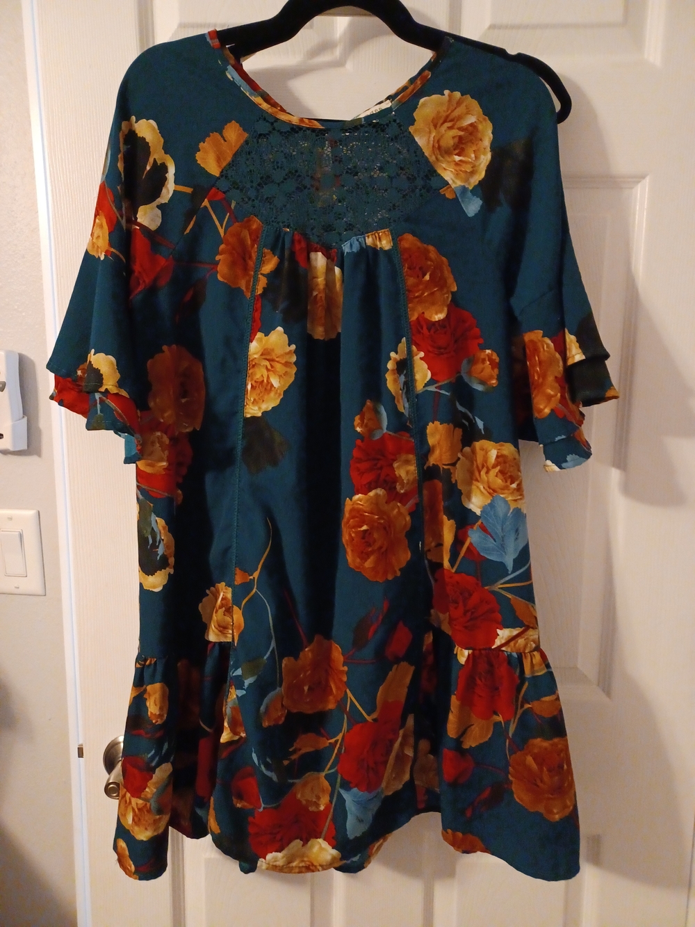 Umgee teal tunic dress features a vibrant floral print and ruffle sleeves.